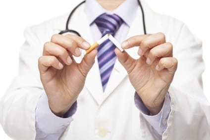 Doctor breaking a cigarette, stop smoking concept. formation arrêt tabac hypnose